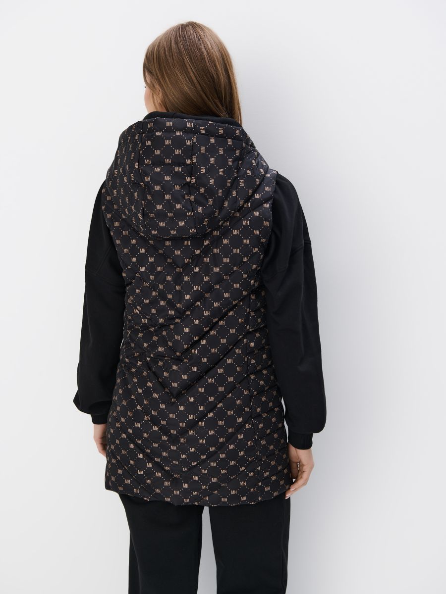 Pikowana kremowa kamizelka z kapturem