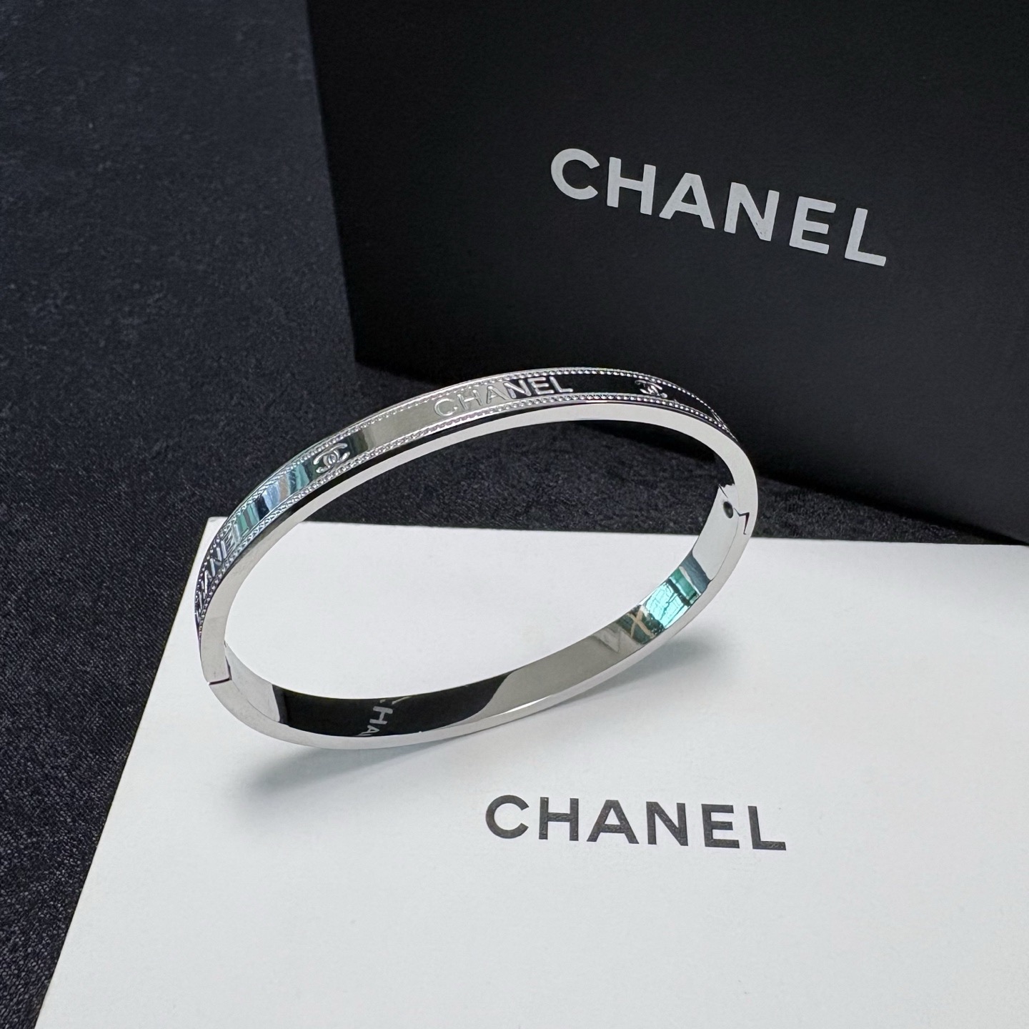Chanel Silver-Tone Logo Bangle with Beaded Edge