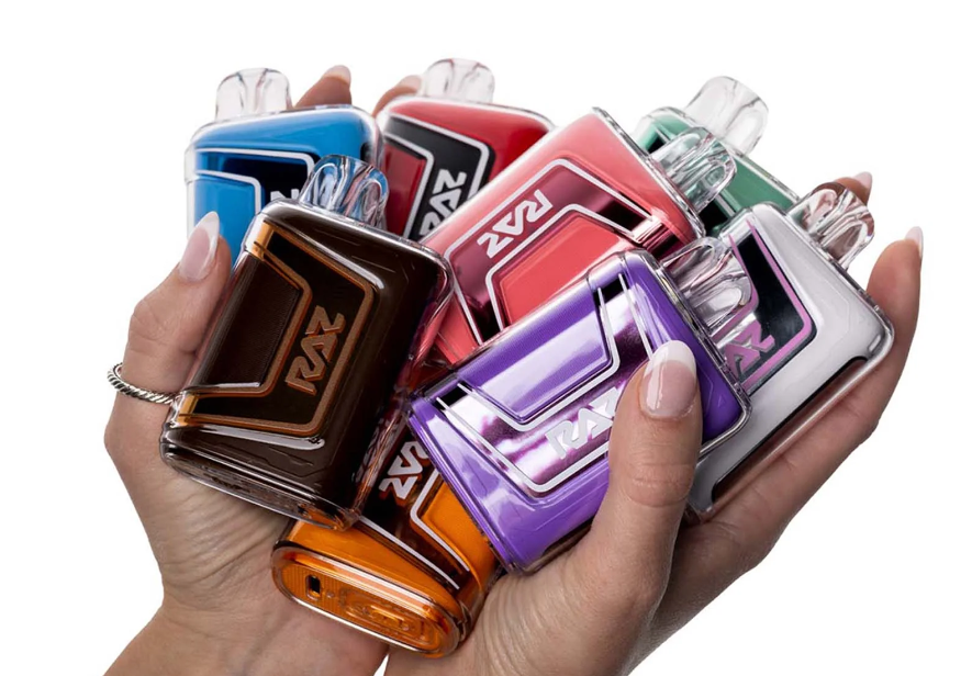 A guy holds RAZ Vape products with elegant appearance shows differences and flavors variety.